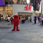 Elmo, with Cookie Monster in the background<br/>